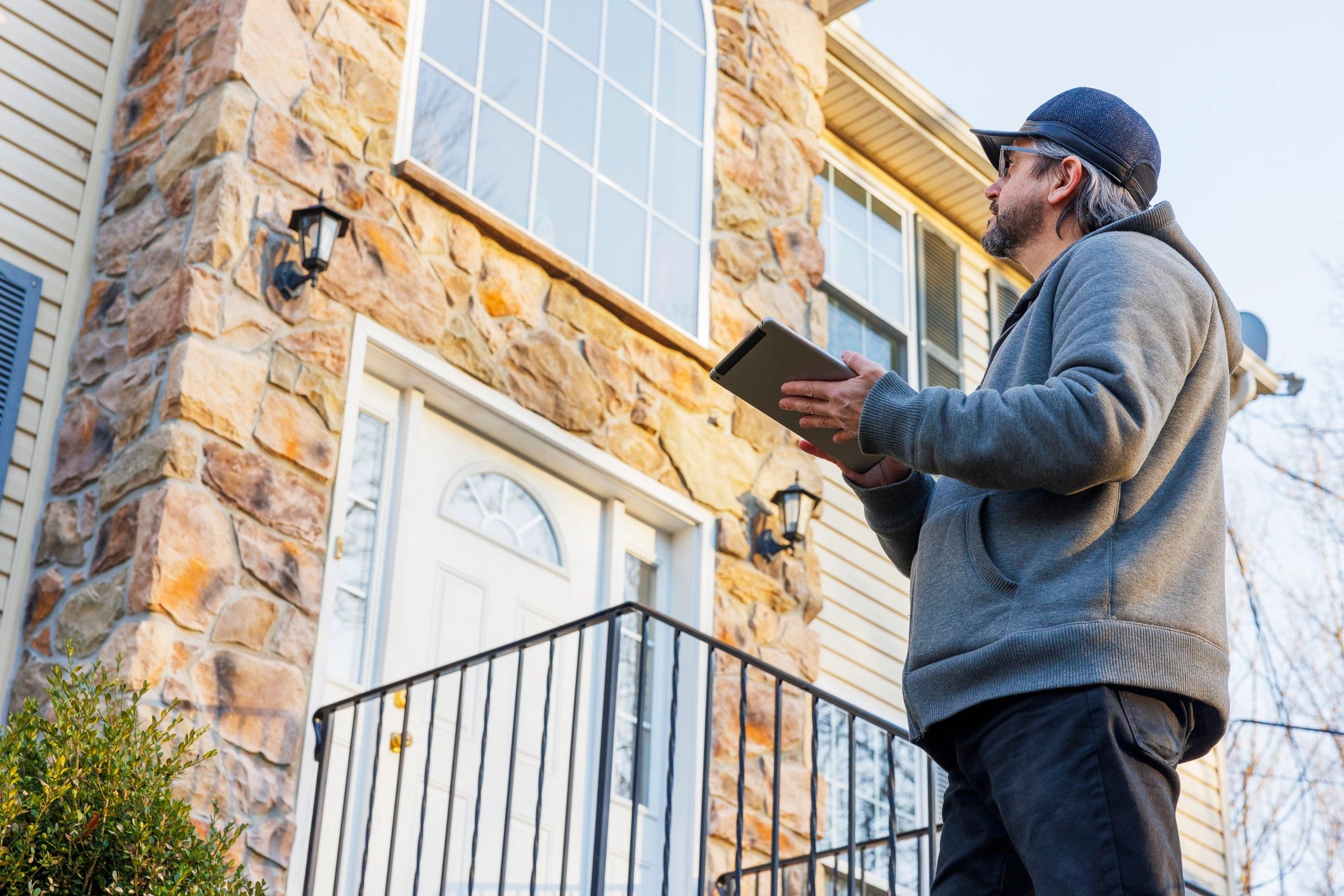 Technician inspecting a home exterior